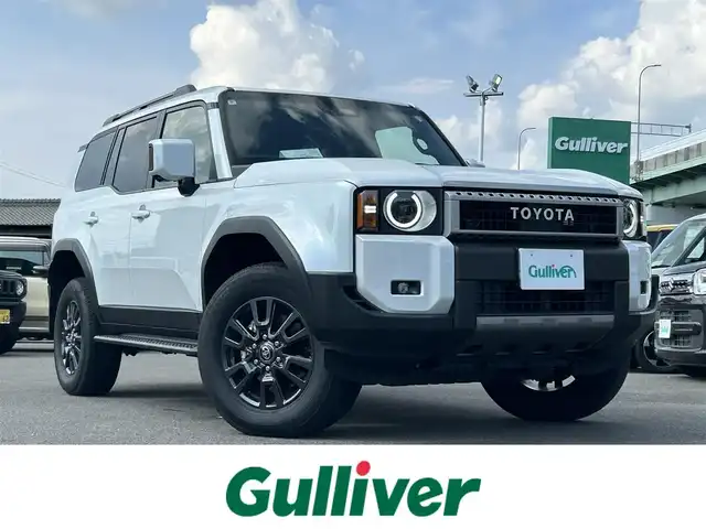 トヨタ ランドクルーザー ２５０ VX 愛知県 2024(令6)年 1.3万km プラチナホワイトパールマイカ サンルーフ/丸目ヘッドライト/ディスプレイオーディオナビ/FM/AM/フルセグTV/BT/Miracast/USB/アラウンドビューモニター/クリアランスソナー/ブラインドスポットモニター/フォグランプ/パワーバックドア/パワーハッチ/デジタルインナーミラー/前席シートヒーター/ルーフレール/衝突被害軽減ブレーキ/スマートキー/トヨタチームメイト/ブラインドスポットモニター/レーダークルーズコントロール（追従走行あり）/本革シート/パーキングサポートブレーキ/純正フロアマット/プッシュスタート/純正18インチアルミホイール
