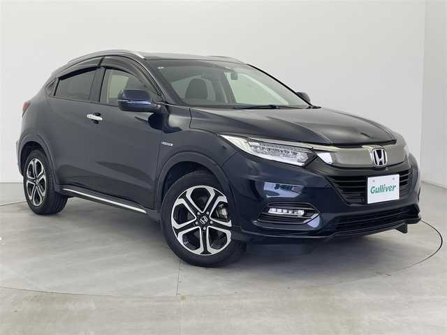 ホンダ ヴェゼル ハイブリッド 富山県 2019(令1)年 6万km ミッドナイトブルービームM 社外ナビ（AM/FM/CD/DVD/USB/SD/BT/HDMI）/フルセグTV/バックカメラ/寒冷地仕様/衝突被害軽減ブレーキ/アダプティブクルーズコントロール/レーンキープアシスト/オートライト/LEDヘッドライト/ハーフレザーシート/前席シートヒーター/ビルトインETC/ドライブレコーダー/パドルシフト/スマートキー×２/プッシュスタート/アイドリングストップ/保証書
