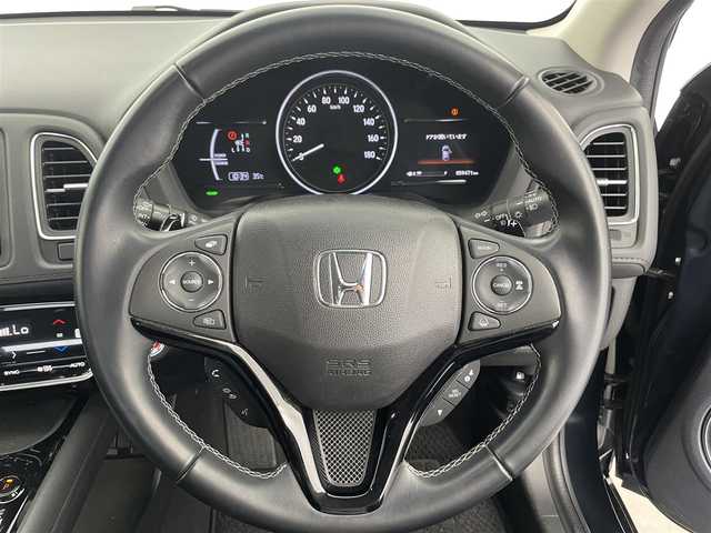 ホンダ ヴェゼル ハイブリッド 富山県 2019(令1)年 6万km ミッドナイトブルービームM 社外ナビ（AM/FM/CD/DVD/USB/SD/BT/HDMI）/フルセグTV/バックカメラ/寒冷地仕様/衝突被害軽減ブレーキ/アダプティブクルーズコントロール/レーンキープアシスト/オートライト/LEDヘッドライト/ハーフレザーシート/前席シートヒーター/ビルトインETC/ドライブレコーダー/パドルシフト/スマートキー×２/プッシュスタート/アイドリングストップ/保証書