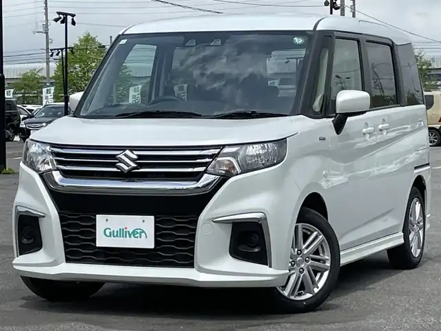 スズキ ソリオ HV MZ 道央・札幌 2024(令6)年 1.4万km ピュアホワイトP ４WD/社外メモリーナビ/AM/FM/BT/スズキセーフティサポート/衝突被害軽減ブレーキ/横滑り防止装置/レーダークルーズコントロール/レーンキープアシスト/リヤパーキングセンサー/バックカメラ/ETC/アイドリングストップ/片側パワースライドドア/前席シートヒーター/ステアリングリモコン/プッシュスタート/スマートキー/ハロゲンヘッドライト/オートライト/オートハイビーム/ヘッドライトレベライザー/電動格納ミラー/ヒーテッドドアミラー/フロアマット/レンタカー登録