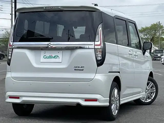 スズキ ソリオ HV MZ 道央・札幌 2024(令6)年 1.4万km ピュアホワイトP ４WD/社外メモリーナビ/AM/FM/BT/スズキセーフティサポート/衝突被害軽減ブレーキ/横滑り防止装置/レーダークルーズコントロール/レーンキープアシスト/リヤパーキングセンサー/バックカメラ/ETC/アイドリングストップ/片側パワースライドドア/前席シートヒーター/ステアリングリモコン/プッシュスタート/スマートキー/ハロゲンヘッドライト/オートライト/オートハイビーム/ヘッドライトレベライザー/電動格納ミラー/ヒーテッドドアミラー/フロアマット/レンタカー登録