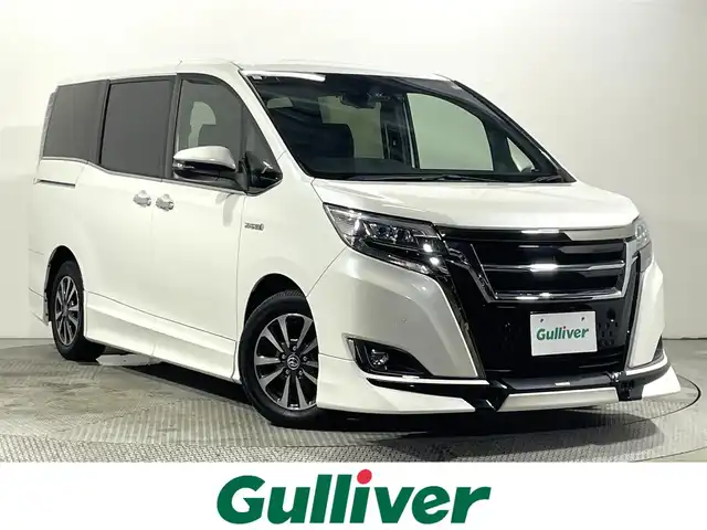 トヨタ エスクァイア ハイブリッド Gi プレミアムパッケージ ブラックテーラード 大阪府 2019(平31)年 3.1万km ホワイトパールクリスタルシャイン TRDエアロ/フロントグリル 10incナビTV バックカメラ ハーフレザー シートヒーター クルーズコントロール 衝突軽減ブレーキ レーンアシスト オートハイビーム 両側パワースライドドア ドライブレコーダー ETC