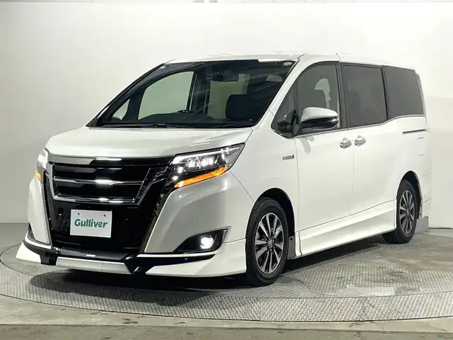 トヨタ エスクァイア ハイブリッド Gi プレミアムパッケージ ブラックテーラード 大阪府 2019(平31)年 3.1万km ホワイトパールクリスタルシャイン TRDエアロ/フロントグリル 10incナビTV バックカメラ ハーフレザー シートヒーター クルーズコントロール 衝突軽減ブレーキ レーンアシスト オートハイビーム 両側パワースライドドア ドライブレコーダー ETC