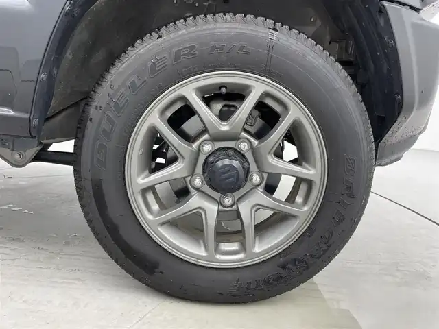 スズキ ジムニー XC 福井県 2023(令5)年 0.5万km ブルーイッシュブラックパール3 ALPINEフローティングディスプレイオーディオ/Bluetooth/USB/AppleCarPlay/AndroidAuto/AM/FM/スズキセーフティーサポート/・デュアルセンサーブレーキサポート/・車線逸脱警報機能/・標識認識機能/・誤発進抑制機能/・ふらつき警報機能/・先行車発進お知らせ機能/クルーズコントロール/プッシュスタート/スペアキー/シートヒーター /オートライト /LED/フォグライト/ヘッドライトウォッシャー/革巻きステアリング/ステアリングチルド機構/背面タイヤ/純正１６インチアルミ