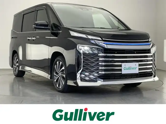 トヨタ ヴォクシー ハイブリッド S－Z 愛知県 2023(令5)年 2万km アティチュードブラックマイカ 純正１０．５型ナビ　快適利便Ｈｉgh　禁煙車　フルセグＴＶ　ＤＶＤデッキ　バックカメラ　ハーフレザー　シートヒーター　パワーバックドア　ＡＣ１００Ｖ　モデリスタシグネチャーイルミ　前後ドラレコ　衝突軽減　シートカバー　セーフティセンス　車線逸脱　モデリスタLEDグリル　LEDオートライト　オートハイビーム　ナノイーXエアコン　コーナーセンサー　クリアランスソナー　電動パーキング