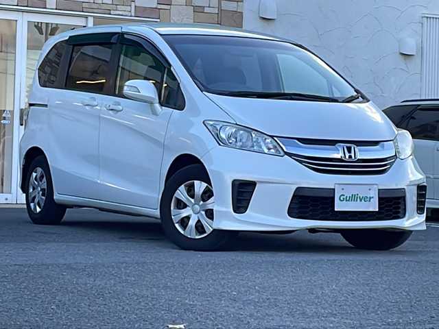 ホンダ フリード G プレミアムエディション 徳島県 2016(平28)年 4.1万km ホワイトオーキッドパール 純正7インチSDナビ/（Bluetooth/フルセグ/CD/DVD）/バックカメラ/純正フリップダウンモニター/両側パワースライドドア/クルーズコントロール/黒半革シート/HIDヘッドライト/オートライト/ビルトインETC/純正フロアマット/電格ミラー/ドアバイザー/スマートキー