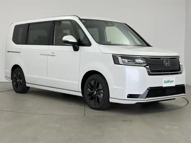 ホンダ ステップワゴン スパーダ eHEV 愛知県 2025(令7)年 0.1千km プラチナホワイトパール 登録済み未使用車/ホンダセンシング/純正11.4インチHONDA　CONNECTナビ/・Bluetooth/・CD/DVD/・AppleCarPlay/・フルセグTV/バックカメラ/ハーフレザー/シートヒーター/電動リアゲード/両側パワースライドドア/格納シート/革巻きステアリング/ステアリングリモコン/純正LEDライト/ディライト/フォグランプ/コーナリングライト/オットマン/純正16インチAW/パドルシフト
