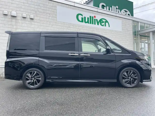 ホンダ ステップワゴン スパーダ クルスピセンシング 山形県 2020(令2)年 2.3万km プレミアムスパークルブラックパール 純正9型メモリーナビゲーション【VXM-227VFNi】/フルセグ　CD DVD　AM FM SD　MUSICRACK　USB　iPod　Bluetooth　/純正後席フリップダウンモニター【VM-185EN】/マルチビューカメラシステム/ブラックスタイル/わくわくゲート/両側電動スライドドア【サンシェード】/ホンダセンシング/CMBS衝突軽減ブレーキ/アダブティブクルーズコントロール/LKAS車線維持支援システム/路外逸脱抑制機能/誤発進抑制機能/先行車発進お知らせ機能/標識認識機能/歩行者事故低減ステアリング/ビルトインETC2.0/純正前後ドライブレコーダー/アイドリングストップ/革巻きステアリング/パドルシフト/プラズマクラスター付きトリプルゾーンオートエアコン/スポーツペダル/超高機能付LED式マップランプ/合皮コンビシート/前席シートバックテーブル/前席シートヒーター/プッシュスタート/スマートキー/LEDヘッドランプ/LEDフロントフォグランプ/オートライト/純正サイド/リアスポイラー/純正17インチアルミホイール/スペアキー