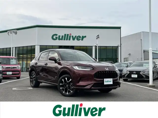 ホンダ ＺＲ－Ｖ ハイブリッド e:HEV Z 愛媛県 2022(令4)年 1.8万km ワイン 禁煙車/登録時走行距離:17952km/純正9型ナビ/フルセグTV/ハンズフリーパワーバックドア/全周囲カメラ/ビルトインETC2.0/アダプティブクルーズコントロール/コーナーセンサー/ホンダセンシング/・衝突軽減ブレーキ/・前後誤発進抑制機能/・車線維持支援システム/・先行車発進お知らせ機能/・標識認識機能/・オートハイビーム/・ブラインドスポットモニター/・後退出庫サポート/LEDヘッドランプ/革巻きステアリング/ステアリングヒーター/パドルシフト/本革シート/前席パワーシート/シートヒーター/運転席ポジションメモリー/純正18インチアルミホイール/スマートキーシステム