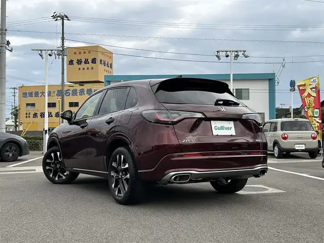 ホンダ ＺＲ－Ｖ ハイブリッド e:HEV Z 愛媛県 2022(令4)年 1.8万km ワイン 禁煙車/登録時走行距離:17952km/純正9型ナビ/フルセグTV/ハンズフリーパワーバックドア/全周囲カメラ/ビルトインETC2.0/アダプティブクルーズコントロール/コーナーセンサー/ホンダセンシング/・衝突軽減ブレーキ/・前後誤発進抑制機能/・車線維持支援システム/・先行車発進お知らせ機能/・標識認識機能/・オートハイビーム/・ブラインドスポットモニター/・後退出庫サポート/LEDヘッドランプ/革巻きステアリング/ステアリングヒーター/パドルシフト/本革シート/前席パワーシート/シートヒーター/運転席ポジションメモリー/純正18インチアルミホイール/スマートキーシステム