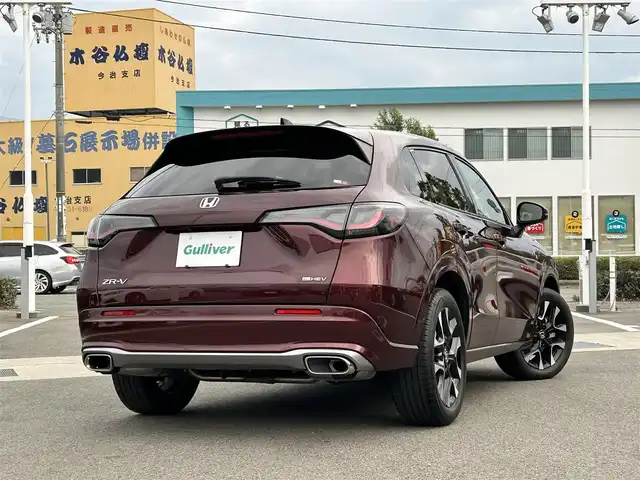 ホンダ ＺＲ－Ｖ ハイブリッド e:HEV Z 愛媛県 2022(令4)年 1.8万km ワイン 禁煙車/登録時走行距離:17952km/純正9型ナビ/フルセグTV/ハンズフリーパワーバックドア/全周囲カメラ/ビルトインETC2.0/アダプティブクルーズコントロール/コーナーセンサー/ホンダセンシング/・衝突軽減ブレーキ/・前後誤発進抑制機能/・車線維持支援システム/・先行車発進お知らせ機能/・標識認識機能/・オートハイビーム/・ブラインドスポットモニター/・後退出庫サポート/LEDヘッドランプ/革巻きステアリング/ステアリングヒーター/パドルシフト/本革シート/前席パワーシート/シートヒーター/運転席ポジションメモリー/純正18インチアルミホイール/スマートキーシステム