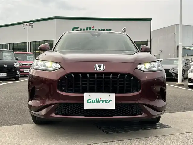 ホンダ ＺＲ－Ｖ ハイブリッド e:HEV Z 愛媛県 2022(令4)年 1.8万km ワイン 禁煙車/登録時走行距離:17952km/純正9型ナビ/フルセグTV/ハンズフリーパワーバックドア/全周囲カメラ/ビルトインETC2.0/アダプティブクルーズコントロール/コーナーセンサー/ホンダセンシング/・衝突軽減ブレーキ/・前後誤発進抑制機能/・車線維持支援システム/・先行車発進お知らせ機能/・標識認識機能/・オートハイビーム/・ブラインドスポットモニター/・後退出庫サポート/LEDヘッドランプ/革巻きステアリング/ステアリングヒーター/パドルシフト/本革シート/前席パワーシート/シートヒーター/運転席ポジションメモリー/純正18インチアルミホイール/スマートキーシステム