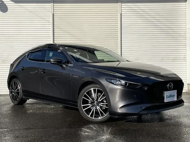 マツダ マツダ３ファストバック 15S ツーリング 福島県 2019(令1)年 1.5万km マシーングレープレミアムM ワンオーナー/純正メモリーナビ/CD/DVD/BT/USB/HDMI/フルセグTV/社外18インチAW(純正AW＋冬タイヤ積込)/360°セーフティパッケージ/レーダークルーズコントロール/ヘッドアップディスプレイ/クリアランスソナー/ステアリングリモコン/ドライブレコーダー/オートライト/LEDヘッドライト/ビルトインETC/プッシュスタート/フロアマット/ドアバイザー/i-stop