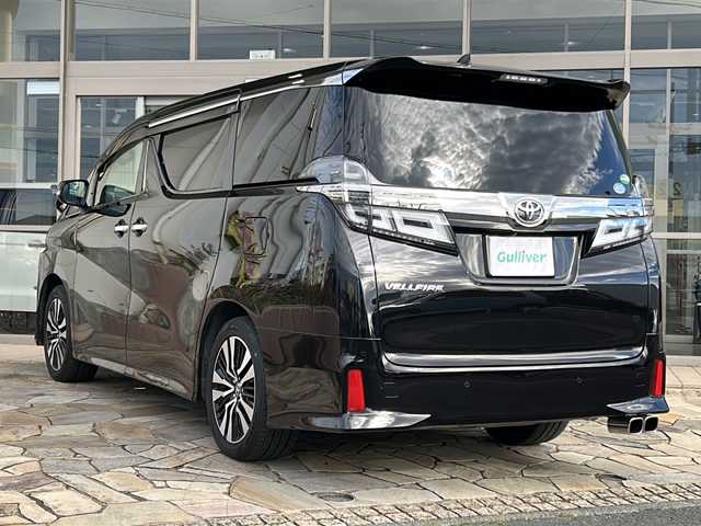 トヨタ ヴェルファイア Z Gエディション 静岡県 2019(令1)年 3.5万km バーニングブラッククリスタルシャインガラスフレーク 【安全装備】/トヨタセーフティセンス/プリクラッシュセーフティ/（ミリ波レーダー・単眼カメラ・昼自転車運転者＆夜間歩行者検知機能付）/（対車両：自車車速域約10km/hから最高速度：最大約40km/h減速可）/（対歩行者：自車車速域約10km/hから80km/h間：最大約30km/h減速可）/レーダークルーズコントロール（全車速追従機能付/ブレーキ制御付）/レーントレーシングアシスト（LTA）（作動車速：50km/h以上時）/（ステアリング操作支援）/ロードサインアシスト（RSA）（道路標識認識支援）/オートマチックハイビーム/【主要装備】/レザーシート　/純正１０インチナビ　/バックカメラ　/フルセグテレビ　/純正１２インチフリップダウンモニター　/三眼ＬＥＤヘッドライト　/トヨタセーフティセンス　/パワーバックドア　/両側パワスラ　/シートヒーター