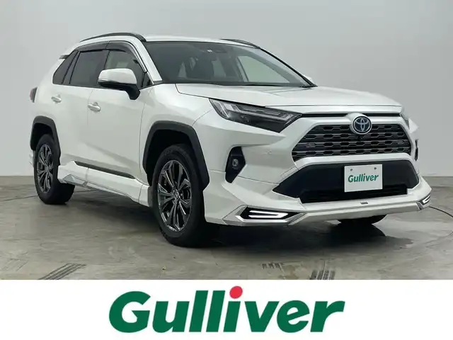 トヨタ ＲＡＶ４ ハイブリッドG 岡山県 2022(令4)年 2.9万km ホワイトパールクリスタルシャイン 純正９インチディスプレイオーディオ/（BT/USB/Carplay/IPod)/衝突軽減ブレーキ/全周囲カメラ/追従型クルーズコントロール/レーンキープアシスト/踏み間違い防止/コーナーセンサー/ブラインドスポットモニター/モデリスタ（前・横・後下）/ルーフレール/シートヒーター(運転席・助手席）/エアシート（運転席・助手席）/電動リアゲート/ステアリングヒーター/ドライブレコーダー（前・後）/パワーシート/電動リアゲート/ＬＥＤヘッドライト/オートハイビーム/オートライト/フォグランプ/プッシュスタート/ビルトインＥＴＣ/スマートキー×1/アイドリングストップ/純正フロアマット/純正18インチAW/ISOFIX/ステアリングスイッチ/チルトステアリング/シートリフター/ウインカーミラー/ドアバイザー/新車保証書/取扱説明書/スペアキー×１