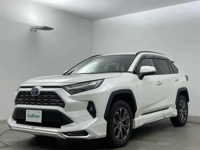 トヨタ ＲＡＶ４ ハイブリッドG 岡山県 2022(令4)年 2.9万km ホワイトパールクリスタルシャイン 純正９インチディスプレイオーディオ/（BT/USB/Carplay/IPod)/衝突軽減ブレーキ/全周囲カメラ/追従型クルーズコントロール/レーンキープアシスト/踏み間違い防止/コーナーセンサー/ブラインドスポットモニター/モデリスタ（前・横・後下）/ルーフレール/シートヒーター(運転席・助手席）/エアシート（運転席・助手席）/電動リアゲート/ステアリングヒーター/ドライブレコーダー（前・後）/パワーシート/電動リアゲート/ＬＥＤヘッドライト/オートハイビーム/オートライト/フォグランプ/プッシュスタート/ビルトインＥＴＣ/スマートキー×1/アイドリングストップ/純正フロアマット/純正18インチAW/ISOFIX/ステアリングスイッチ/チルトステアリング/シートリフター/ウインカーミラー/ドアバイザー/新車保証書/取扱説明書/スペアキー×１
