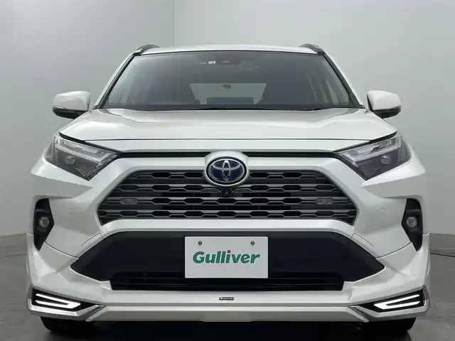 トヨタ ＲＡＶ４ ハイブリッドG 岡山県 2022(令4)年 2.9万km ホワイトパールクリスタルシャイン 純正９インチディスプレイオーディオ/（BT/USB/Carplay/IPod)/衝突軽減ブレーキ/全周囲カメラ/追従型クルーズコントロール/レーンキープアシスト/踏み間違い防止/コーナーセンサー/ブラインドスポットモニター/モデリスタ（前・横・後下）/ルーフレール/シートヒーター(運転席・助手席）/エアシート（運転席・助手席）/電動リアゲート/ステアリングヒーター/ドライブレコーダー（前・後）/パワーシート/電動リアゲート/ＬＥＤヘッドライト/オートハイビーム/オートライト/フォグランプ/プッシュスタート/ビルトインＥＴＣ/スマートキー×1/アイドリングストップ/純正フロアマット/純正18インチAW/ISOFIX/ステアリングスイッチ/チルトステアリング/シートリフター/ウインカーミラー/ドアバイザー/新車保証書/取扱説明書/スペアキー×１