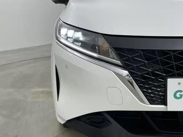 日産 ノート X 岡山県 2023(令5)年 1.7万km ピュアホワイトパール 純正9インチナビ/・FM/AM/Bluetooth/フルセグ/CarPlay/HDMI/インテリジェントアラウンドビューモニター/インテリジェントルームミラー/ワイヤレス充電/三眼LEDヘッドライト/ETC2.0/ドライブレコーダー/インテリジェントエマージェンシーブレーキ/踏み間違い防止/車線逸脱警報/防止支援システム/BSM/コーナーセンサー/オートブレーキホールド/USB入力端子/純正フロアマット