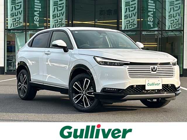 ホンダ ヴェゼル ハイブリッド e:HEV Z 岡山県 2025(令7)年 0.1万km未満 プラチナホワイトパール 登録済未使用車/純正メモリナビ/（USB/Bluetooth/フルセグTV//AppleCarPlay/AndroidAuto）/バックカメラ/ホンダセンシング/コーナーセンサー（前後）/アダクティブクルーズコントロール/プリクラッシュセーフティー/LKA/ブラインドスポットモニター/横滑り防止装置/盗難防止装置/カーテンエアバッグ/ダウンアシストコントロール/パワーバックドア/ハーフレザーシート/シートヒーター（D/N席）/ステアリングヒーター/パドルシフト/ビルトインETC2.0/LEDヘッドライト/オートライト/オートマチックハイビーム/MTモード付AT/ワイヤレス充電