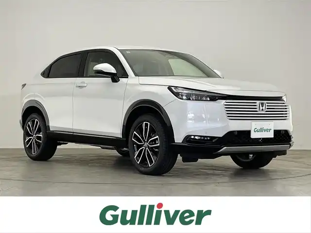 ホンダ ヴェゼル ハイブリッド e:HEV Z 滋賀県 2025(令7)年 0.1万km未満 プラチナホワイトパール 登録済未使用車/純正９インチナビ/（Bluetooth/フルセグ/TV/USB/AppleCarplay/AndroidAuto)/追従型クルーズコントロール/レーンキープアシスト/前後クリアランスソナー/電動パワーバックドア/純正ビルトインETC2.0/前方ドライブレコーダー/ワイヤレス充電/前席シートヒーター/ステアリングヒーター/衝突軽減ブレーキ/オートブレーキホールド/LEDライト/オートライト/ダウンヒルアシストコントロール/ハーフレザーシート/エンジンプッシュスタート/スマートキー/ステアリングスイッチ