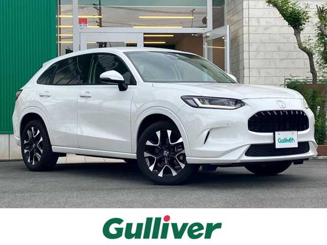 ホンダ ＺＲ－Ｖ Z 静岡県 2023(令5)年 2.7万km プラチナホワイトパール Honda SENSING/ブラインドスポットインフォメーション/後退出庫サポート/アダプティブドライビングビーム/マルチビューカメラシステム/Honda CONNECTディスプレー/ETC2.0車載器/ワイヤレス充電器/本革シート/運転席8ウェイ助手席4ウェイパワーシート(ドライビングポジションシステム付)/運転席＆助手席シートヒーター/BOSEプレミアムサウンドシステム(12スピーカー)/ハンズフリーアクセスパワーテールゲート(予約クローズ機能付)/純正18インチアルミホイール(切削＋ベルリナブラック)/エンジンスタートボタン/パワーステアリング/パワーウィンドウ/スマートキー/オートエアコン/クルーズコントロール/USB入力端子/純正フロアマット/ABS/横滑り防止装置/コーナーセンサー前後/レーンキープアシスト/オートライト/オートマチックハイビーム/ダウンヒルアシストコントロール/LEDヘッドライト/W＋サイドエアバック/衝突軽減システム/カーテンエアバック/衝突軽減システム/ステアリングヒーター