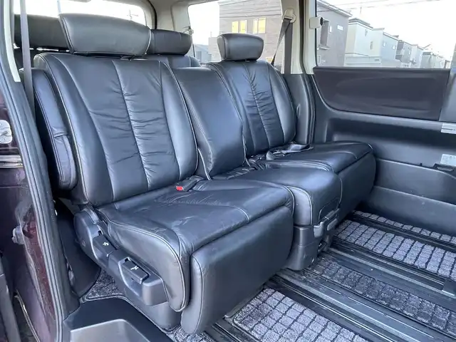 日産 エルグランド 250ハイウェイスター ブラックレザ-ナビ 道央・札幌 2008(平20)年 8.6万km ディープカシス ４WD/社外メモリーナビ/AM/FM/CD/DVD/BT/AUX/ワンセグ/社外フリップダウンモニター/コーナーセンサー/バックカメラ/フロントカメラ/両側パワースライドドア/D席パワーシート/前席シートヒーター/オットマン/レザーシート/革巻きウッドコンビステアリング/ステアリングリモコン/MTモード付AT/スマートキー/オートライト/フォグランプ/キセノンヘッドライト/電動格納ミラー/ウィンカーミラー/純正フロアマット/ドアバイザー/スペアキー