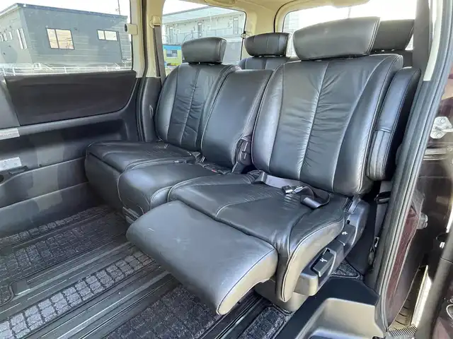 日産 エルグランド 250ハイウェイスター ブラックレザ-ナビ 道央・札幌 2008(平20)年 8.6万km ディープカシス ４WD/社外メモリーナビ/AM/FM/CD/DVD/BT/AUX/ワンセグ/社外フリップダウンモニター/コーナーセンサー/バックカメラ/フロントカメラ/両側パワースライドドア/D席パワーシート/前席シートヒーター/オットマン/レザーシート/革巻きウッドコンビステアリング/ステアリングリモコン/MTモード付AT/スマートキー/オートライト/フォグランプ/キセノンヘッドライト/電動格納ミラー/ウィンカーミラー/純正フロアマット/ドアバイザー/スペアキー