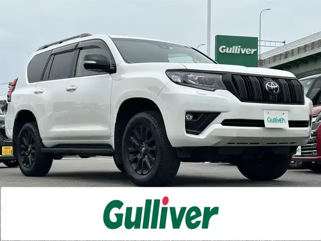 トヨタ ランドクルーザー プラド TX Lパッケージ マットブラED 愛知県 2023(令5)年 1.8万km ホワイトパールクリスタルシャイン 〇純正9インチディスプレイオーディオ/(ナビ、フルセグTV、BT）/〇バックカメラ/〇パノラミックビューモニター/〇ビルトインETC2.0/〇ドライブレコーダー/〇7人乗り/〇サンルーフ/〇トヨタセーフティセンス/〇レーダークルーズコントロール/〇プリクラッシュセーフティー/〇ブラインドスポットモニター/〇LEDヘッドランプ/〇オートライト/〇フォグランプ/〇純正18インチAW/〇革巻きステアリング/〇左右独立オートエアコン/〇ベージュ革シート/〇シートヒーター/〇シートベンチレーション/〇パワーシート/〇スマートエントリー/〇スペアタイヤ/〇取説、保証書