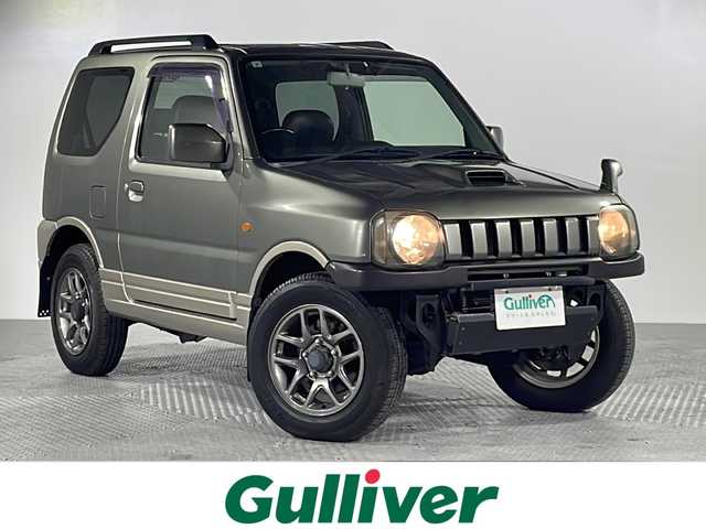スズキ ジムニー ランドベンチャー 沖縄県 2004(平16)年 4.7万km オリーブグレーメタリック ・禁煙車/・ターボ車/・ＫＥＮＷＯＯＤナビ（フルセグテレビ、Ｂｌｕｅｔｏｏｔｈ、ＣＤ、ＤＶＤ）/・ＥＴＣ/・シートヒーター/・フォグランプ/・トランスファーレバー/・ハーフレザーシート/・純正アルミホイール/・ルーフレール/・キーレスエントリー/・マッドガード/・純正ドアバイザー