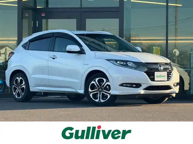 ホンダ ヴェゼル ハイブリッド Z ホンダセンシング 東京都 2017(平29)年 2.6万km ホワイトオーキッドパール 純正8インチナビ(VXM-175VFEi)/【CD/DVD/FM/AM/TV/BT/SD/USB/ ipod/VTR/AUX/HDMI】/バックカメラ/ビルトインETC/前後ドライブレコーダー/衝突軽減ブレーキ/車線維持システム/アダクティブクルーズコントロール/パワーシート/シートメモリー/シートヒーター/レザーシート/パドルシフト/LEDヘッドライト/LEDフォグライト/純正17インチAW/プッシュスタート/スマートキー/スペアキー×１