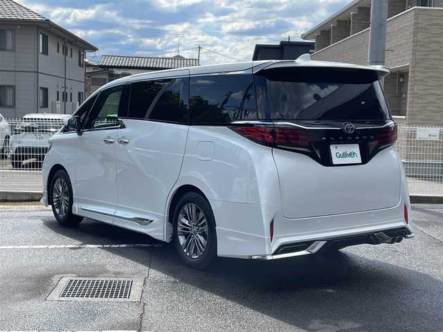 トヨタ アルファード Z 福島県 2025(令7)年 0.1万km プラチナホワイトパールマイカ ワンオーナー/ディスプレイオーディオPlus/AM/FM/BT/USB/HDMI/Miracast/フルセグTV/MODELLISTA エアロパーツセット/（REGAL DIGNITY STYLE）/左右独立ムーンルーフ/13.2型有機EL後席ディスプレイ/デジタルインナーミラー/パノラミックビューモニター/トヨタセーフティセンス/レーダークルーズコントロール/クリアランスソナー/ブラインドスポットモニター/両側パワースライドドア/パワーバックドア/合成皮革ブラックレザーシート/パワーシート/シートヒーター/エアシート/ステアリングヒーター/オートハイビーム/3眼LEDヘッドライト/ビルトインETC 2.0/USB充電ポート/おくだけ充電/フロアマット