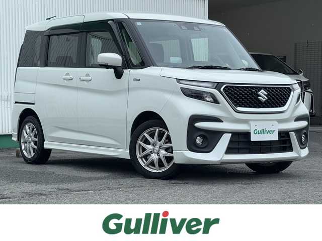 スズキ ソリオ バンディット HV MV 徳島県 2023(令5)年 2.7万km ピュアホワイトP 純正ナビ・フルセグＴＶ・ＣＤ・DVD再生・Bluetooth・USB接続・AMFMチューナー/衝突被害軽減システム/コーナーセンサー/車線逸脱警報装置/前席シートヒーター/プッシュスタート・スマートキー/社外15インチアルミホイール/LEDヘッドライト・フォグランプ/ダブル・サイドエアバック/純正フロアマット/ウィンカーミラー