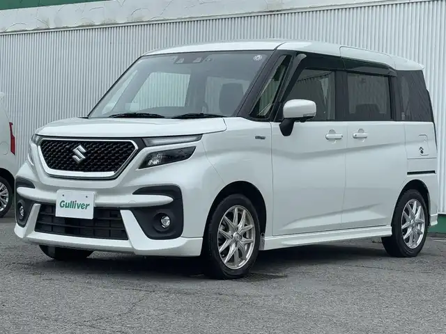 スズキ ソリオ バンディット HV MV 徳島県 2023(令5)年 2.7万km ピュアホワイトP 純正ナビ・フルセグＴＶ・ＣＤ・DVD再生・Bluetooth・USB接続・AMFMチューナー/衝突被害軽減システム/コーナーセンサー/車線逸脱警報装置/前席シートヒーター/プッシュスタート・スマートキー/社外15インチアルミホイール/LEDヘッドライト・フォグランプ/ダブル・サイドエアバック/純正フロアマット/ウィンカーミラー