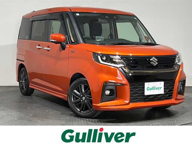 スズキ ソリオ HV SZ 愛媛県 2023(令5)年 1.3万km フレイムオレンジPM ・１０型ナビ/（フルセグＴＶ・ＢＴ・ＣＤ・ＤＶＤ・ＳＤ・ＦＭ・ＡＭ・ＵＳＢ）/・全方位カメラ　/・前後ドラレコ　/・両側パワースライドドア　/・ＤＮ席シートヒーター　/・ＵＳＢ充電　/・レーダークルーズコントロール/・レーンキープアシスト/・ヘッドアップディスプレイ/・サーキュレーター