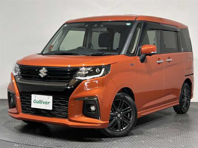 スズキ ソリオ HV SZ 愛媛県 2023(令5)年 1.3万km フレイムオレンジPM ・１０型ナビ/（フルセグＴＶ・ＢＴ・ＣＤ・ＤＶＤ・ＳＤ・ＦＭ・ＡＭ・ＵＳＢ）/・全方位カメラ　/・前後ドラレコ　/・両側パワースライドドア　/・ＤＮ席シートヒーター　/・ＵＳＢ充電　/・レーダークルーズコントロール/・レーンキープアシスト/・ヘッドアップディスプレイ/・サーキュレーター