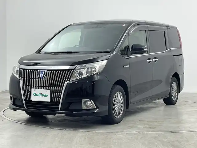 トヨタ エスクァイア ハイブリッド Gi 群馬県 2014(平26)年 8万km ブラック 純正９型ナビ　純正１１型後席モニター　バックカメラ　クルーズコントロール　シートヒーター　両側パワースライドドア　ＬＥＤヘッドライト　ＥＴＣ　純正アルミホイール１５インチ　オートライト　禁煙車