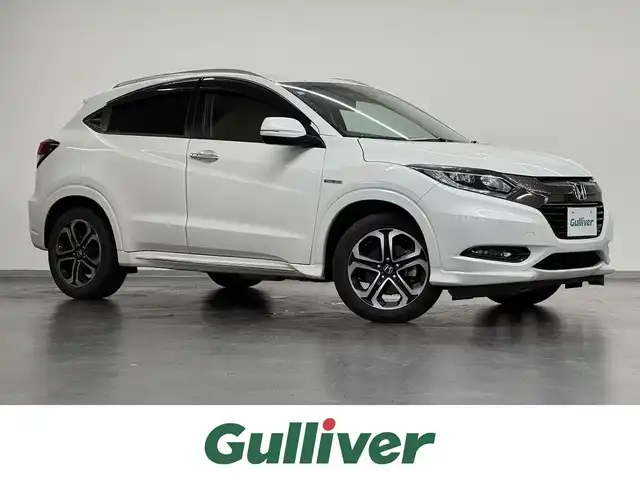 ホンダ ヴェゼル ハイブリッド Z ホンダセンシング 三重県 2016(平28)年 5.8万km ホワイトオーキッドパール ハイブリッド/FF/i-DCD（MTモード付フロア7DCT）/純正 8インチナビ VXM-175VFEi/（CD/DVD/FM/AM/TV/Music Rack/iPod/SD/USB/Bluetooth/Apple CarPlay/VTR）/ALPINE 9インチ後席モニター TMX-RM905/バックカメラ/ドライブレコーダー 前方/ビルトイン ETC/Honda SENSING/・衝突軽減ブレーキ［CMBS］/・車線維持支援システム［LKAS］/・アダプティブクルーズコントロール［ACC］/・路外逸脱抑制機能/・標識認識機能/・先行車発進お知らせ機能/・リアクティブフォースペダル［RFP］/装備/・ハーフレザーシート/・シートヒーター（D/N）/・左右独立オートエアコン/・雨滴検知オートワイパー/・パドルシフト/・電子パーキングブレーキ＋オートブレーキホールド/・ルームミラー型レーダー探知機/・熱線入りフロントワイパー/・ステアリングスイッチ/・後席チップアップ機能/・純正17inAW/・保/取/・スマートキー/など