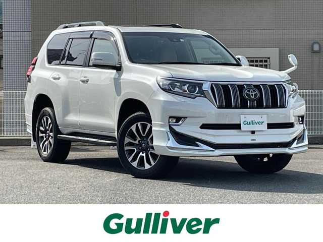 トヨタ ランドクルーザー プラド TX Lパッケージ 山口県 2022(令4)年 3.1万km ホワイトパールクリスタルシャイン サンルーフ/ベージュ革シート/前席パワーシート/前席エアシート シートヒーター/モデリスタ エアロ (F/Ru)/9型SDナビ フルセグTV CD DVD BT/バックカメラ/フロントカメラ/スマートキー 2個/コーナーセンサー/スマートルームミラー/衝突被害軽減ブレーキ/レーダークルーズコントロール/レーンアシスト/オートマチックハイビーム/ビルトイン ETC/ドラレコ/LEDオートヘッドライト/フォグライト/W サイド カーテン ニー エアバッグ/禁煙車
