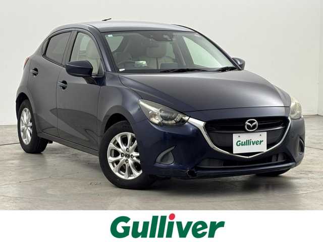 マツダ デミオ 13S Lパッケージ 福岡県 2014(平26)年 6万km ディープクリスタルブルーマイカ 純正ＳＤナビ　/ＥＴＣ　/前方ドライブレコーダー　/衝突被害軽減システム　/横滑り防止　/アイドリングストップ　/アクセル踏み間違い防止　/ＨＵＤ/レザーシート　/純正１５インチＡＷ　/純正フロアマット　/オートライト