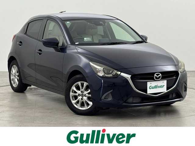 マツダ デミオ 13S Lパッケージ 福岡県 2014(平26)年 6万km ディープクリスタルブルーマイカ 純正ＳＤナビ　/ＥＴＣ　/前方ドライブレコーダー　/衝突被害軽減システム　/横滑り防止　/アイドリングストップ　/アクセル踏み間違い防止　/ＨＵＤ/レザーシート　/純正１５インチＡＷ　/純正フロアマット　/オートライト