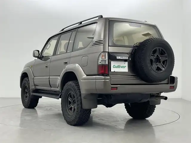 トヨタ ランドクルーザー プラド TX ワイド 熊本県 1999(平11)年 10.6万km シルバーM/シルバーM 禁煙車　/４ＷＤ　/社外ナビ（ＣＤ・ＤＶＤ・フルセグ・ＢＴ）/バックカメラ　/ＥＴＣ　/社外フロアマット　/社外１６インチＡＷ　/ルーフレール　/背面タイヤ/電動格納ミラー