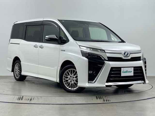トヨタ ヴォクシー ハイブリッド ZS 煌Ⅱ 埼玉県 2020(令2)年 6.7万km ホワイトパールクリスタルシャイン 純正ナビ/　(Bluetooth/CD/DVD/FM/AM)/純正フリップダウンモニター/フルセグテレビ/バックカメラ/ビルトインETC/運転席・助手席シートヒーター/両側パワースライドドア/クルーズコントロール/衝突被害軽減ブレーキ/車線逸脱警報/クリアランスソナー/オートハイビーム/オートLEDライト/プッシュスタート/純正16インチアルミホイール