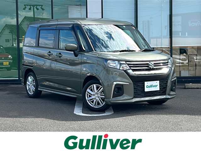 スズキ ソリオ HV MX 岐阜県 2023(令5)年 0.9万km タフカーキパールメタリック 登録時走行距離9039km/純正８型メモリーナビ/Bluetoothオーディオ/フルセグＴＶ/バックカメラ/片側パワースライドドア/禁煙車/レーダークルーズコントロール/レーンキープアシスト/前方ドライブレコーダー/後方コーナーセンサー/シートヒーター/純正15インチアルミホイール/オートライト/ETC/USB充電ポート/純正フロアマット/プッシュスタート/スマートキー/スペアキー/ドアバイザー