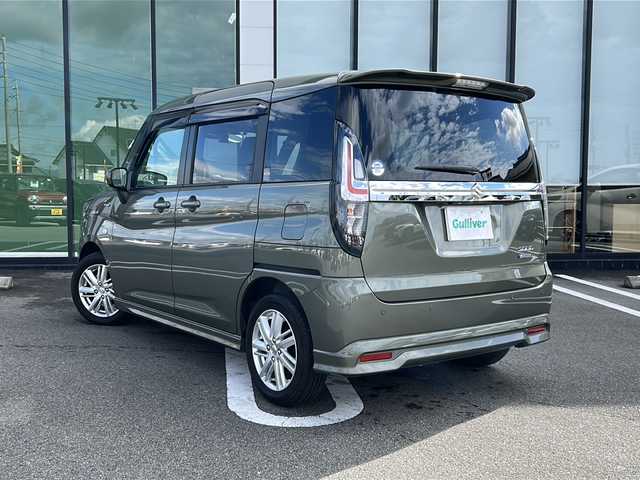 スズキ ソリオ HV MX 岐阜県 2023(令5)年 0.9万km タフカーキパールメタリック 登録時走行距離9039km/純正８型メモリーナビ/Bluetoothオーディオ/フルセグＴＶ/バックカメラ/片側パワースライドドア/禁煙車/レーダークルーズコントロール/レーンキープアシスト/前方ドライブレコーダー/後方コーナーセンサー/シートヒーター/純正15インチアルミホイール/オートライト/ETC/USB充電ポート/純正フロアマット/プッシュスタート/スマートキー/スペアキー/ドアバイザー