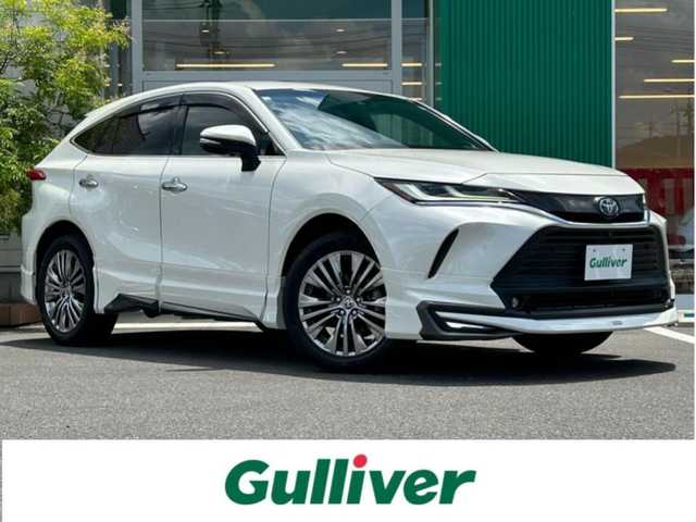 トヨタ ハリアー ハイブリッド Z レザーパッケージ 岡山県 2020(令2)年 4.6万km ホワイトパールクリスタルシャイン 12.3インチJBLサウンドディプレイオーディオ /フルセグTV、Bluetooth、Apple Carplay/Android Auto、AM、FM/パノラミックビューモニター/デジタルインナーミラー（前後録画機能付き）/モデリスタエアロ AVANT EMOTIONAL STYLE/ビルトインETC/前席パワーシート/運転席メモリーシート/前席シートヒーター/前席ベンチレーション/本革シート（ブラウン）/ステアリングヒーター/パワーバックドア/ヘッドアップディスプレイ/電動パーキングブレーキ/ブレーキホールド/トヨタセーフティセンス/・プリクラッシュセーフティ/・レーントレーシングアシスト/・レーダークルーズコントロール/・アダブティブハイビームシステム/・ロードサインアシスト/パーキングサポートブレーキ/先行車発進告知機能/車両接近通報装置/純正エンジンスターター