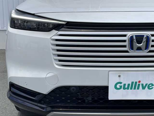 ホンダ ヴェゼル ハイブリッド e:HEV Z 三重県 2025(令7)年 0.1万km未満 プラチナホワイトパール 登録済未使用/BSM/置くだけ充電/LEDシーケンシャルウィンカー/シートヒーター(前席)/ステアリングヒーター/ハンズフリー電動リヤゲート/ホンダコネクトディスプレイナビ(TV/BT/AppleCarPlay/AndroidAuto/USB）/ホンダセンシング/ステアリングヒーター/レーンキープアシスト/レーダークルーズコントロール/横滑り防止/衝突軽減ブレーキ/パーキングセンサー/先行車発進お知らせ/電動格納ミラー/禁煙車