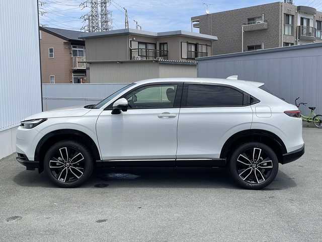 ホンダ ヴェゼル ハイブリッド e:HEV Z 三重県 2025(令7)年 0.1万km未満 プラチナホワイトパール 登録済未使用/BSM/置くだけ充電/LEDシーケンシャルウィンカー/シートヒーター(前席)/ステアリングヒーター/ハンズフリー電動リヤゲート/ホンダコネクトディスプレイナビ(TV/BT/AppleCarPlay/AndroidAuto/USB）/ホンダセンシング/ステアリングヒーター/レーンキープアシスト/レーダークルーズコントロール/横滑り防止/衝突軽減ブレーキ/パーキングセンサー/先行車発進お知らせ/電動格納ミラー/禁煙車