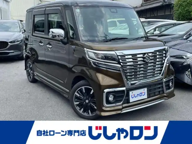 スズキ スペーシア カスタム HYBRID XS ターボ 大阪府 2018(平30)年 10.4万km ブレイブカーキパール/ブラック2トーン (株)IDOMが運営する【じしゃロン東大阪店】の自社ローン専用車両になります。こちらは現金またはオートローンご利用時の価格です。自社ローンご希望の方は別途その旨お申付け下さい/7インチＳＤナビ(MDV-D504BTW)/(AM/FM/CD/DVD/Bluetooth/iPod/USB/SD/フルセグTV)/バックカメラ/衝突軽減ブレーキ/レーンキープアシスト/クルーズコントロール/コーナーセンサー/両側パワースライドドア/横滑り防止装置/ハーフレザーシート/運転席シートヒーター/アイドリングストップ/電動格納ミラー/革巻きステアリング/ステアリングスイッチ/パドルシフト/オートライト/LEDヘッドライト/フロントフォグ/オートマチックハイビーム/純正フロアマット/純正ドアバイザー/プッシュスタート/スマートキー/スペアキー