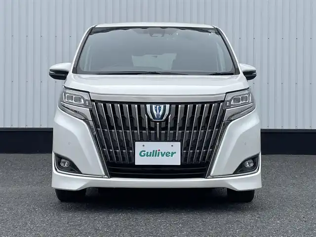 トヨタ エスクァイア ハイブリッド Gi プレミアムパッケージ 千葉県 2020(令2)年 6万km ホワイトパールクリスタルシャイン アルパイン9インチナビ/(フルセグTV/BT/CD/DVD/FM/AM)/バックカメラ/衝突被害軽減システム/車線逸脱警報/クルーズコントロール/アルパイン12インチフリップダウンモニター/ハーフレザーシート/両側パワースライドドア/横滑り防止装置/ETC/前後ドライブレコーダー/アイドリングストップ/LEDヘッドライト/フォグランプ/オートライト/ウィンカーミラー/電動格納ミラー/純正15インチAW/シートヒーター/シートリフター/ステアリングヒーター/プッシュスタート/スマートキー/フロアマット/スペアキー/取扱説明書