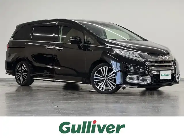 ホンダ オデッセイ アブソルート EX ADV 三重県 2015(平27)年 7.1万km クリスタルブラックパール ガソリン/FF/MTモード付インパネCVT/純正 7インチナビ/（FM/AM/CD/DVD/USB/iPod/Bluetooth/TV/HDMI/後席HDMI）/純正 9インチ後席モニター/マルチビューカメラシステム（360カメラ）/両側パワースライドドア/ビルトインETC/Honda SENSING/・衝突軽減ブレーキ［CMBS］/・車線維持支援システム［LKAS］/・路外逸脱抑制機能/・アダプティブクルーズコントロール［ACC］/・先行車発進お知らせ機能/・ブラインドスポットシステム/・標識認識機能（常駐表示機能付）/・スマートパーキングアシストシステム/装備/・ハーフレザーシート/・パワーシート（D8way）/・トリプルゾーンコントロール・フルオートエアコン（前席左右＋後席）/・プレミアムクレードル2ndシート（オットマン・バックシェル付）/・オートライト/・LEDヘッドライト/・電動格納ドアミラー（ヒーター付）/・パドルシフト/・ステアリングスイッチ/・社外AW（18×7J ＋52 114.3-5）あり/・プッシュスタート/・スマートキーx3/など